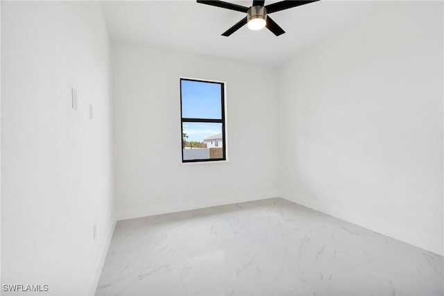 4115 20th St SW, Lehigh Acres, FL 33976 - empty room with baseboards, ceiling fan, and marble finish floor