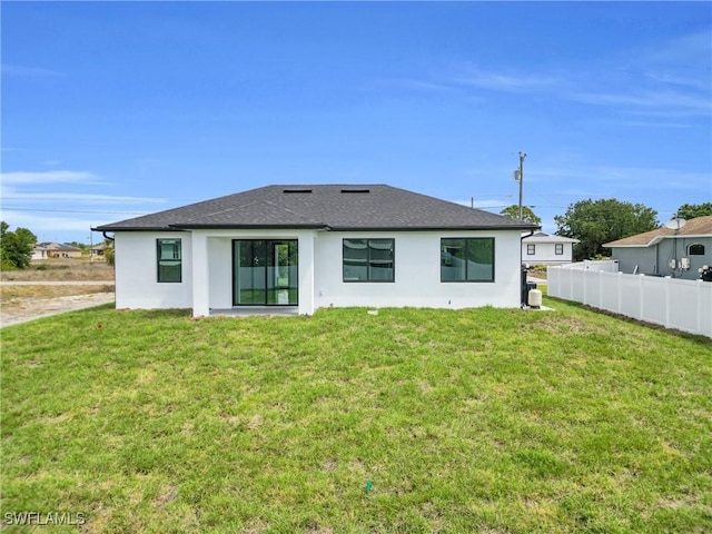 4115 20th St SW, Lehigh Acres, FL 33976 - back of house featuring a lawn, fence, roof with shingles, and stucco siding