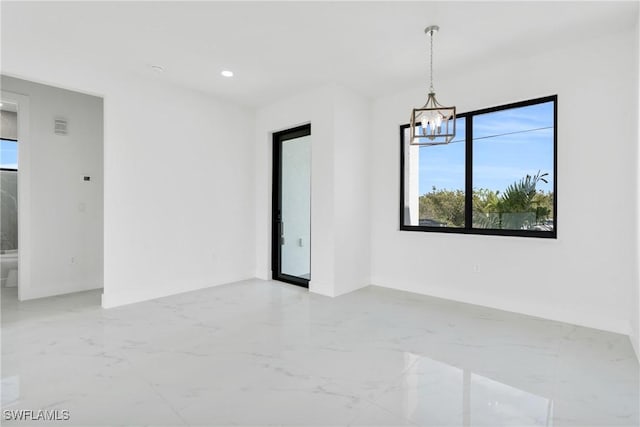 4115 20th St SW, Lehigh Acres, FL 33976 - unfurnished room featuring recessed lighting, baseboards, an inviting chandelier, and marble finish floor