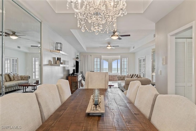 2000 Royal Marco Way Unit 607, Marco Island, FL 34145 - dining area featuring a ceiling fan, a tray ceiling, and a chandelier