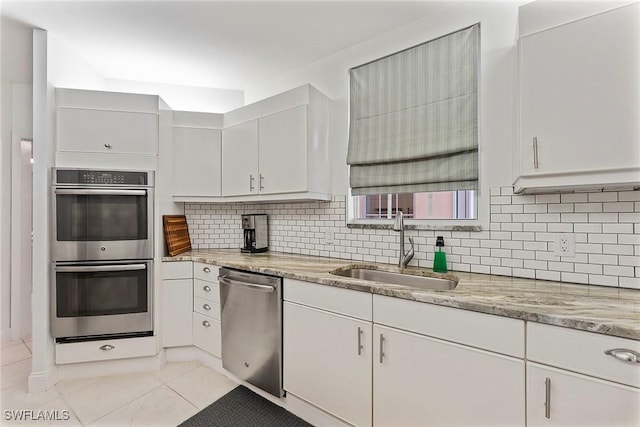2000 Royal Marco Way Unit 607, Marco Island, FL 34145 - kitchen featuring appliances with stainless steel finishes, a sink, tasteful backsplash, and white cabinets