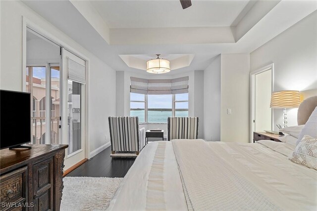 2000 Royal Marco Way Unit 607, Marco Island, FL 34145 - bedroom with multiple windows, a raised ceiling, wood finished floors, and access to exterior