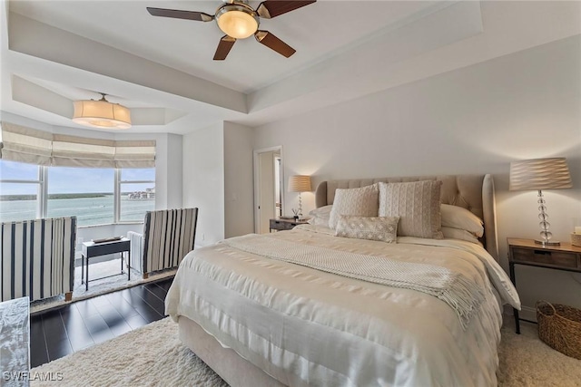 2000 Royal Marco Way Unit 607, Marco Island, FL 34145 - bedroom featuring a raised ceiling, a water view, dark wood-type flooring, and ceiling fan
