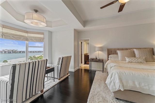 2000 Royal Marco Way Unit 607, Marco Island, FL 34145 - bedroom featuring dark wood finished floors, a water view, a raised ceiling, and baseboards
