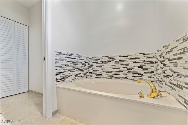 2000 Royal Marco Way Unit 607, Marco Island, FL 34145 - bathroom with a garden tub, tile patterned flooring, and a closet