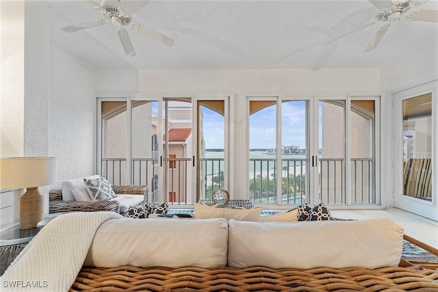 2000 Royal Marco Way Unit 607, Marco Island, FL 34145 - living area featuring a ceiling fan, a water view, and a textured wall