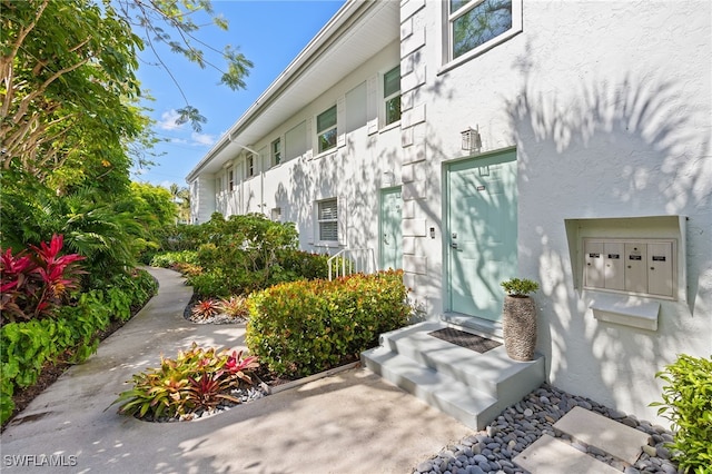 360 10th Ave S Unit B200, Naples, FL 34102 - doorway to property featuring stucco siding
