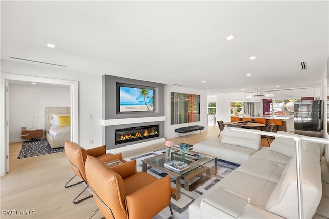 360 10th Ave S Unit B200, Naples, FL 34102 - living area with a glass covered fireplace, recessed lighting, light wood-type flooring, and visible vents
