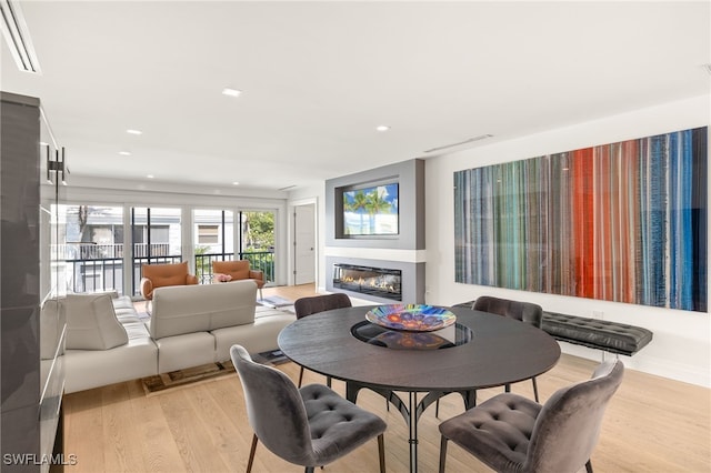 360 10th Ave S Unit B200, Naples, FL 34102 - dining room featuring visible vents, a glass covered fireplace, recessed lighting, and light wood finished floors