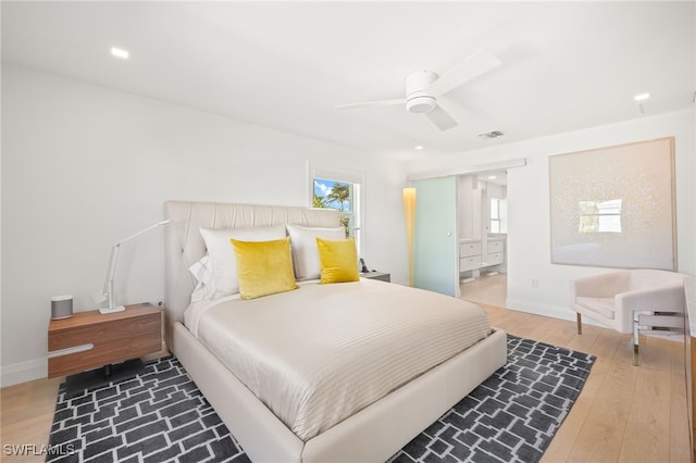 360 10th Ave S Unit B200, Naples, FL 34102 - bedroom featuring connected bathroom, a ceiling fan, baseboards, wood finished floors, and visible vents