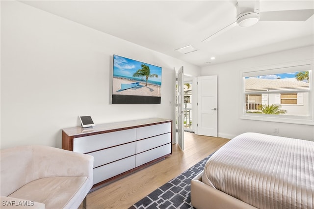 360 10th Ave S Unit B200, Naples, FL 34102 - bedroom with baseboards, wood finished floors, and multiple windows