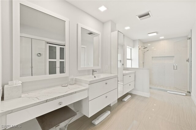 360 10th Ave S Unit B200, Naples, FL 34102 - full bath with visible vents, a sink, two vanities, and a shower stall