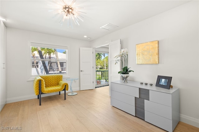 360 10th Ave S Unit B200, Naples, FL 34102 - sitting room with baseboards, visible vents, light wood-type flooring, and a chandelier