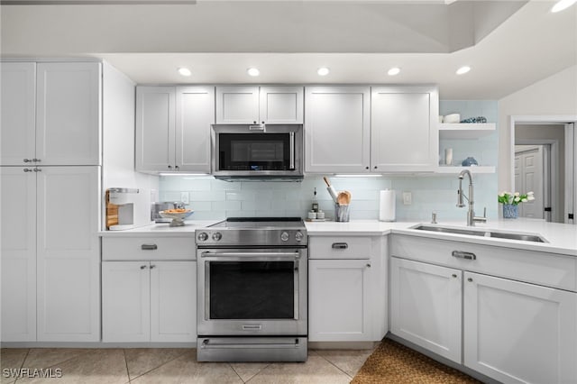 1904 Timberline Dr, Naples, FL 34109 - kitchen featuring stainless steel appliances, a sink, light countertops, recessed lighting, and backsplash