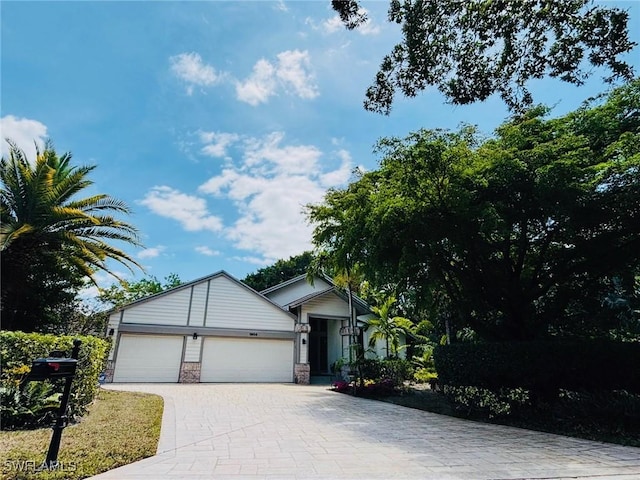 1904 Timberline Dr, Naples, FL 34109 - ranch-style house with an attached garage and decorative driveway