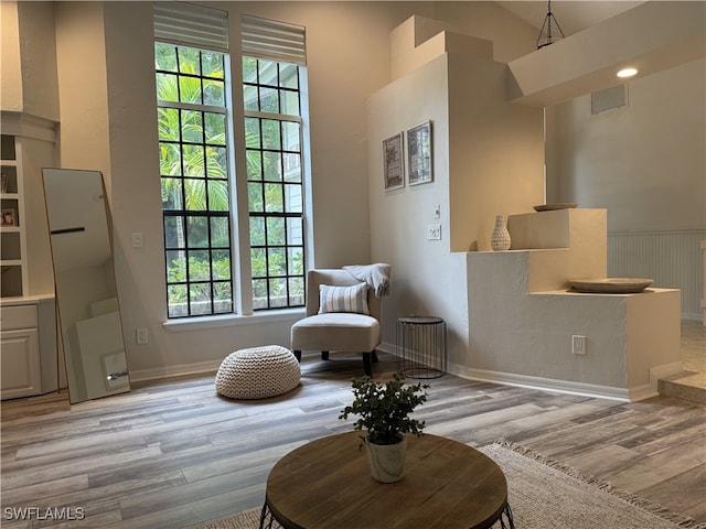 1904 Timberline Dr, Naples, FL 34109 - sitting room with wood finished floors, baseboards, and vaulted ceiling