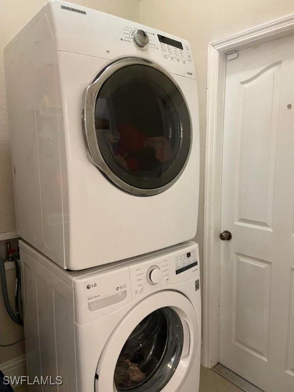 washroom with stacked washer and clothes dryer
