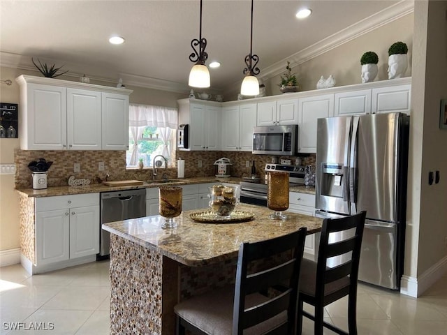 kitchen with appliances with stainless steel finishes, light tile patterned flooring, ornamental molding, white cabinetry, and recessed lighting