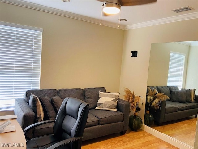 home office featuring light wood finished floors and crown molding