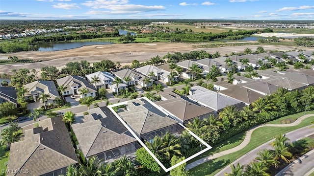 aerial view featuring a water view, golf course view, and a residential view