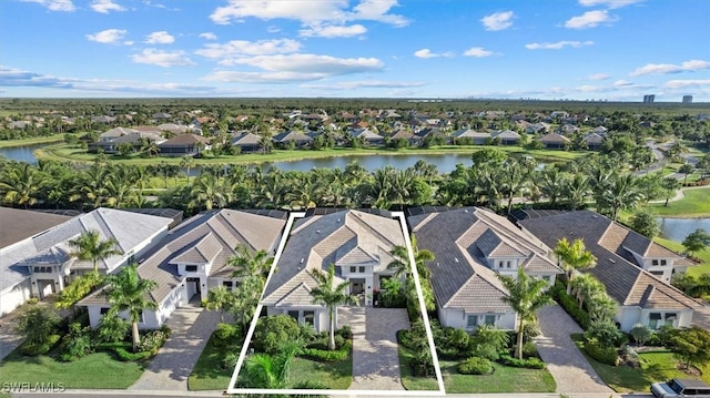 birds eye view of property with a water view and a residential view