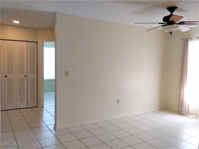 9265 Lake Park Dr Unit 201, Fort Myers, FL 33919 - empty room featuring a ceiling fan, a textured ceiling, and light tile patterned flooring
