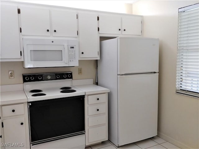 9265 Lake Park Dr Unit 201, Fort Myers, FL 33919 - kitchen featuring white cabinets, white appliances, light countertops, baseboards, and light tile patterned floors
