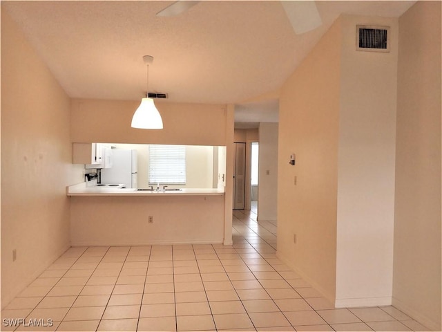 9265 Lake Park Dr Unit 201, Fort Myers, FL 33919 - interior space featuring visible vents, freestanding refrigerator, a sink, and hanging light fixtures
