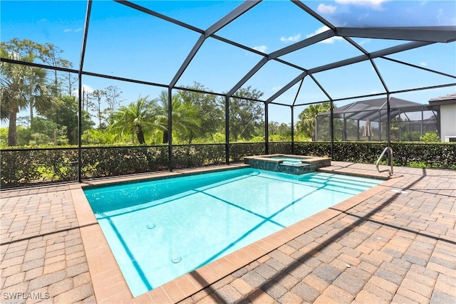 17186 Ashcomb Way, Estero, FL 33928 - view of swimming pool featuring a pool with connected hot tub, glass enclosure, and a patio