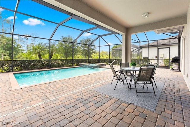 17186 Ashcomb Way, Estero, FL 33928 - view of swimming pool featuring a patio, a pool with connected hot tub, glass enclosure, and area for grilling