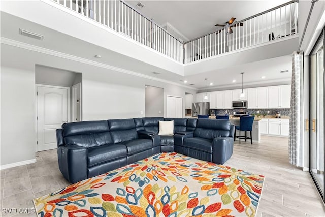 17186 Ashcomb Way, Estero, FL 33928 - living area with a high ceiling, ornamental molding, a ceiling fan, light wood-type flooring, and recessed lighting