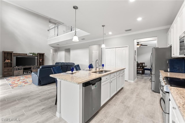 17186 Ashcomb Way, Estero, FL 33928 - kitchen featuring appliances with stainless steel finishes, a sink, white cabinets, a ceiling fan, and crown molding