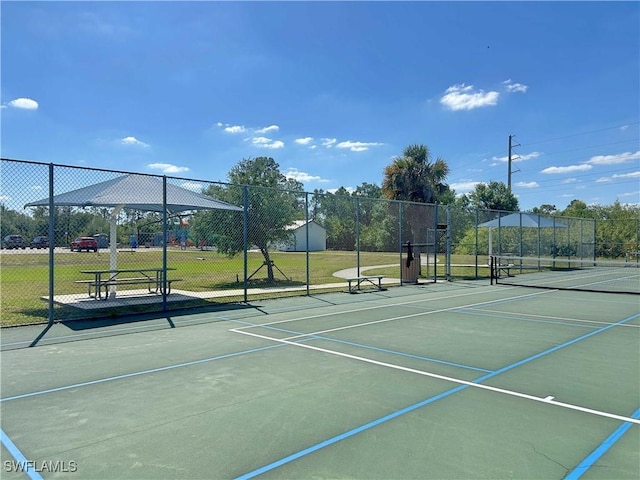 view of tennis court with fence