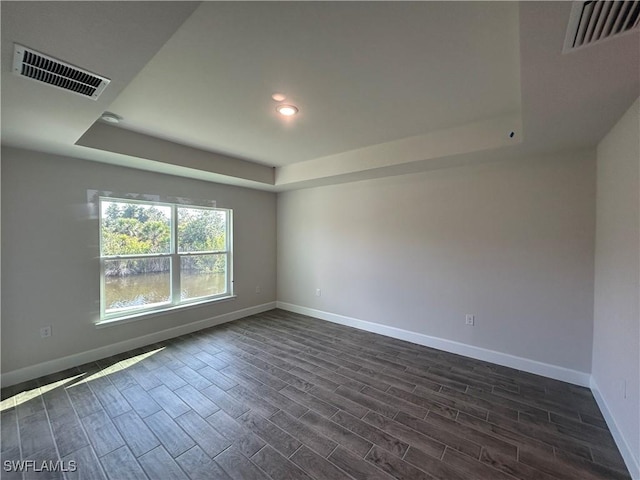 411 Paramaribo St, Punta Gorda, FL 33983 - empty room with a tray ceiling, dark wood-style floors, and recessed lighting