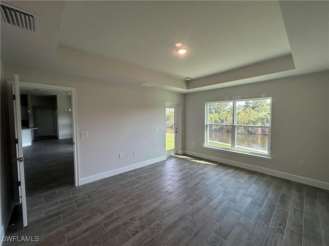 411 Paramaribo St, Punta Gorda, FL 33983 - empty room with a raised ceiling, dark wood finished floors, and recessed lighting
