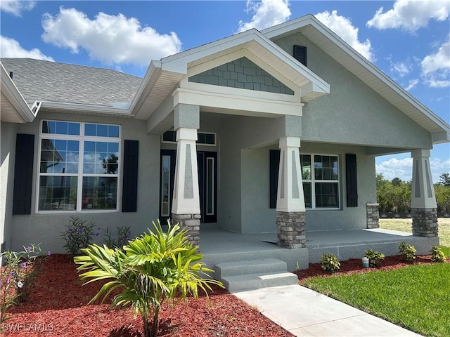 411 Paramaribo St, Punta Gorda, FL 33983 - view of front of property featuring covered porch, stucco siding, and stone siding