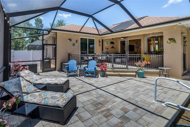 view of patio / terrace with glass enclosure, ceiling fan, and outdoor lounge area
