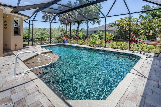 outdoor pool featuring a patio and a lanai