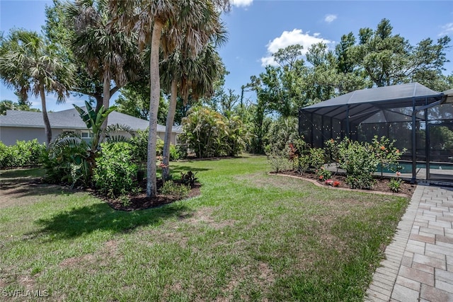 view of yard with an outdoor pool and a lanai