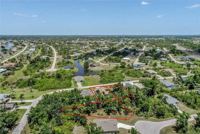 drone / aerial view featuring a water view and a residential view