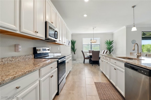 kitchen with crown molding, a healthy amount of sunlight, appliances with stainless steel finishes, and a sink