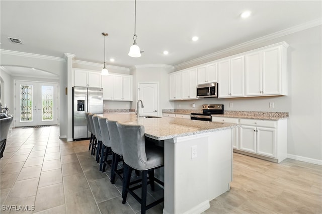 kitchen with recessed lighting, visible vents, a sink, a kitchen breakfast bar, and stainless steel appliances
