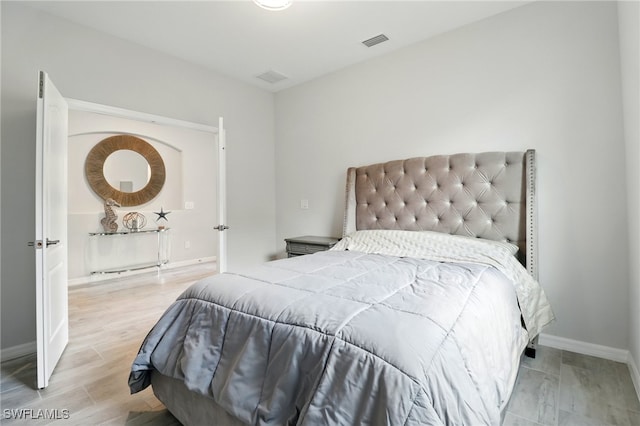 bedroom featuring visible vents and baseboards