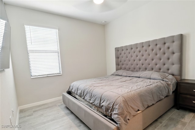 bedroom with baseboards and a ceiling fan