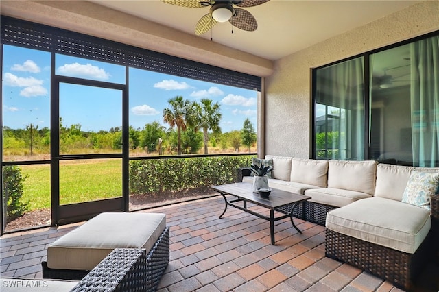 sunroom featuring outdoor lounge area and ceiling fan