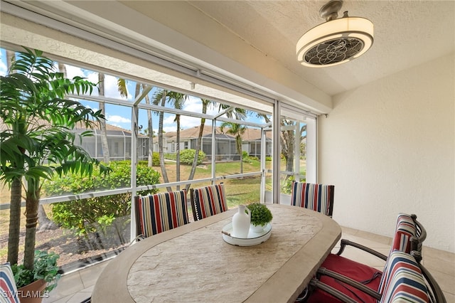 sunroom / solarium featuring a residential view and outdoor dining space