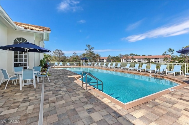 pool featuring a patio area and fence