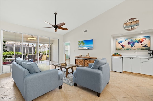 living room featuring ceiling fan, visible vents, a healthy amount of sunlight, and high vaulted ceiling