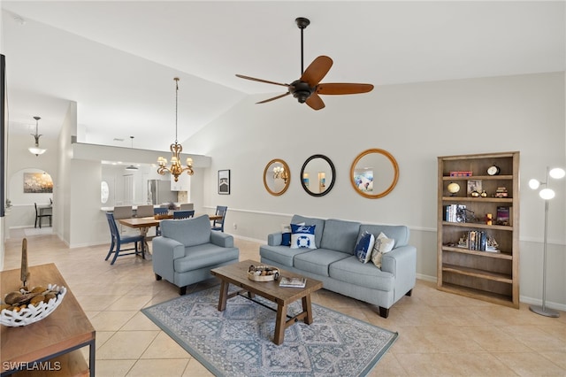 living room with baseboards, high vaulted ceiling, light tile patterned floors, and ceiling fan with notable chandelier