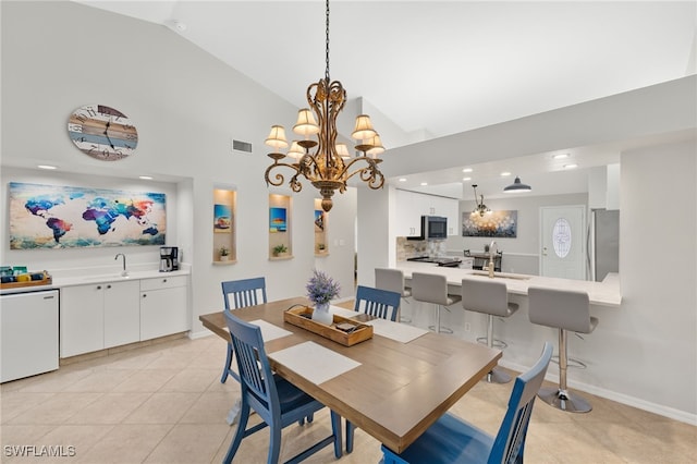 dining space with light tile patterned floors, high vaulted ceiling, baseboards, and visible vents